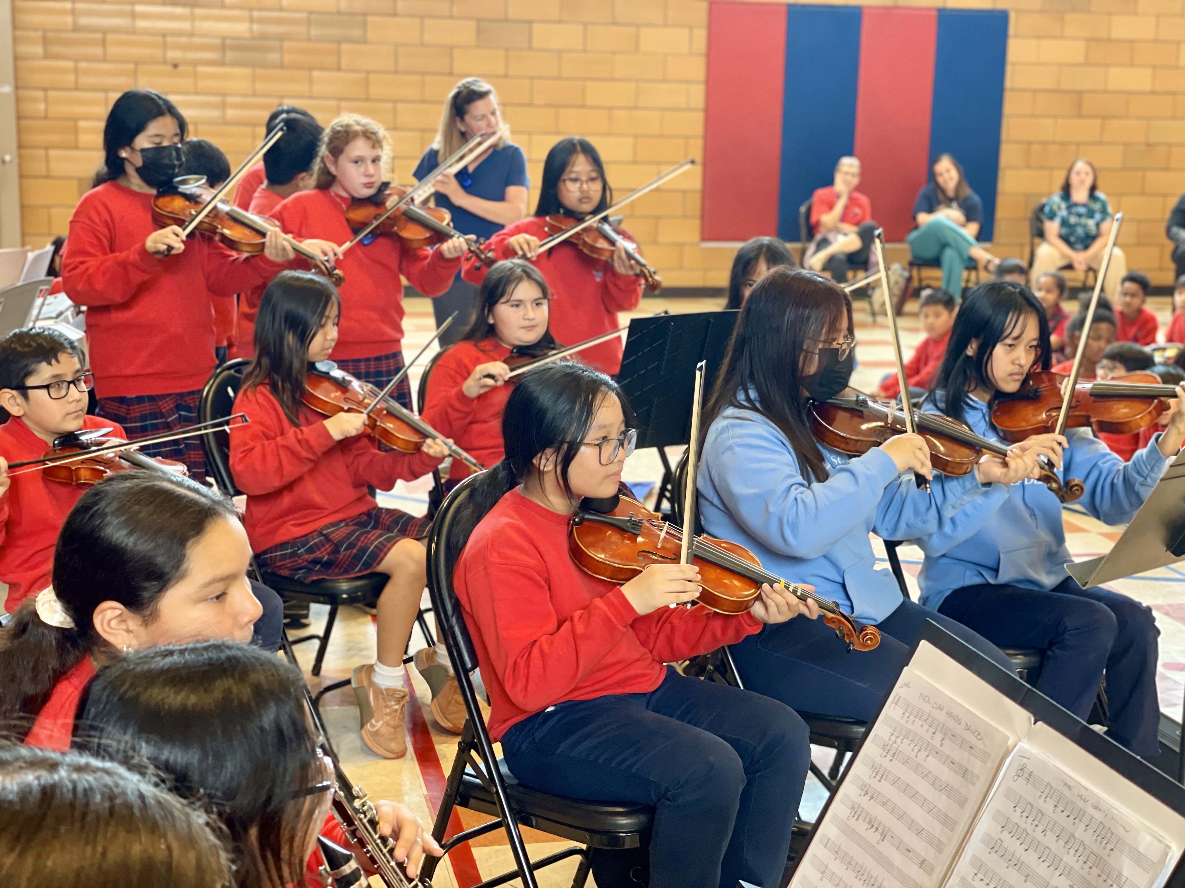 Students playing a violin concert